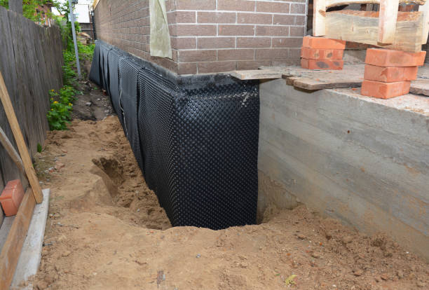 SJ Waterproofing Pros technician performing targeted Basement Waterproofing assessment in Fenton, MI